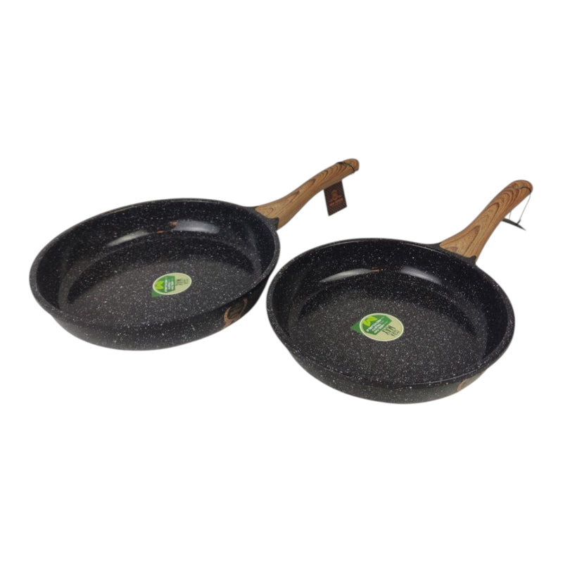 Two black frying pans with wooden handles on a white background