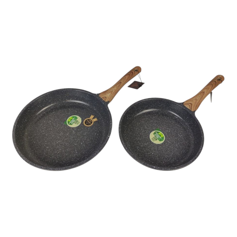Two black frying pans with wooden handles on a white background