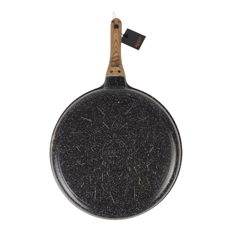 Black speckled frying pan with wooden handle on a white background