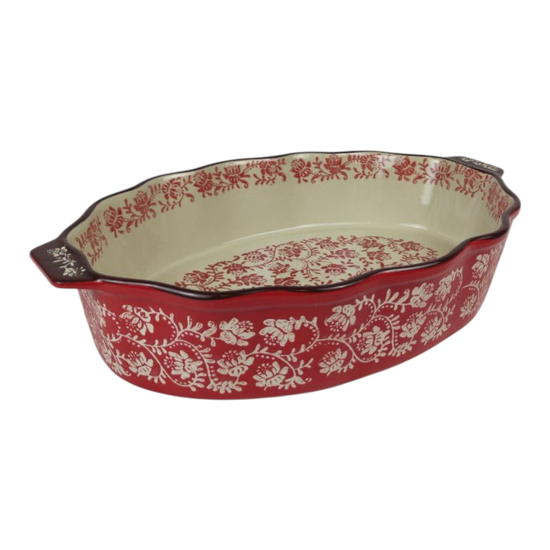Decorative ceramic baking dish with red floral pattern on a white background