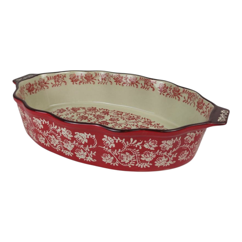 Decorative ceramic baking dish with red floral pattern on a white background