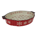 Red ceramic pie dish with snowflake pattern on a white background