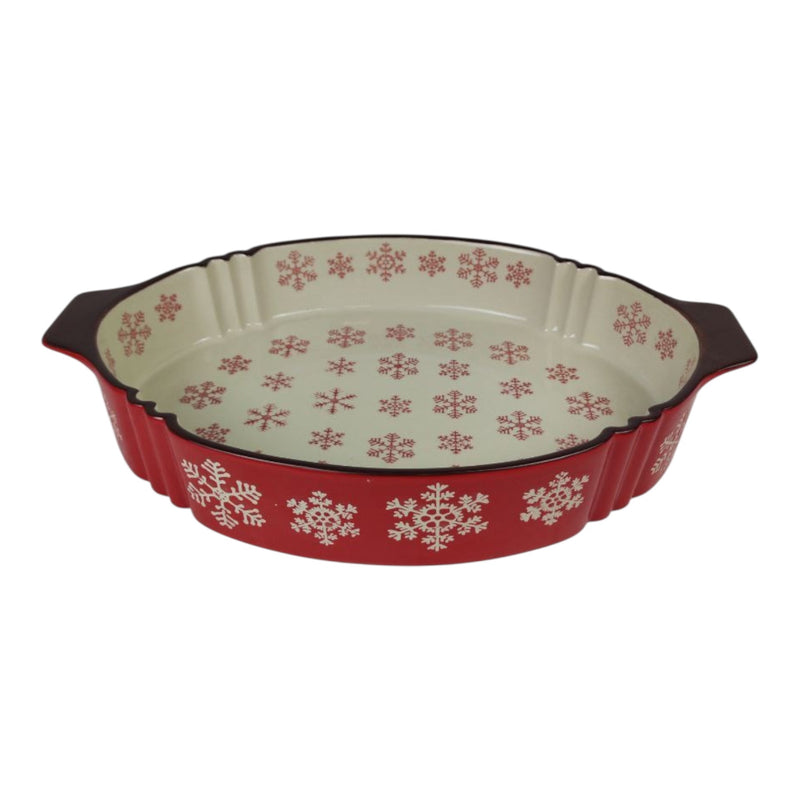 Decorative ceramic pie dish with red and white snowflake pattern on a white background