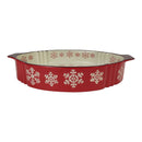 Red ceramic baking dish with snowflake patterns on a white background