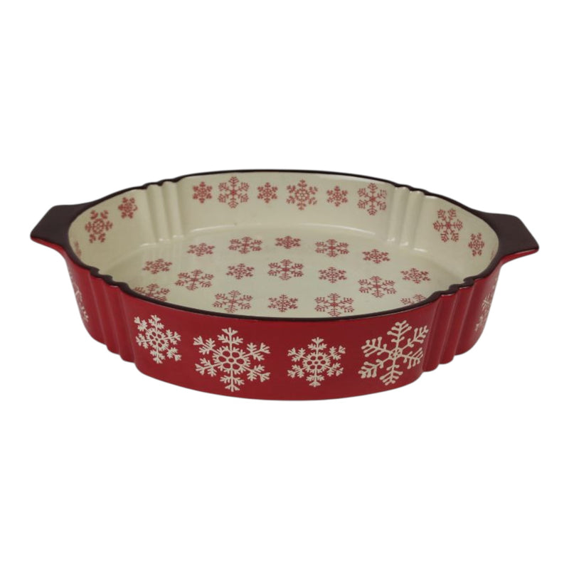 Red ceramic baking dish with snowflake pattern on a white background