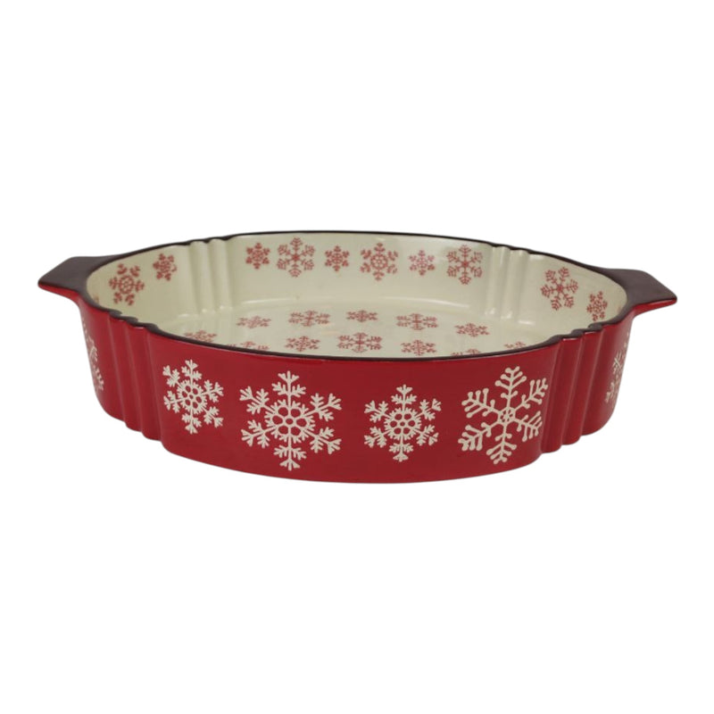 Red ceramic baking dish with snowflake patterns on a white background