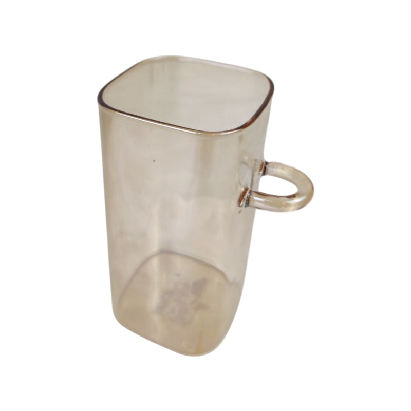 Clear glass mug with a handle on a white background