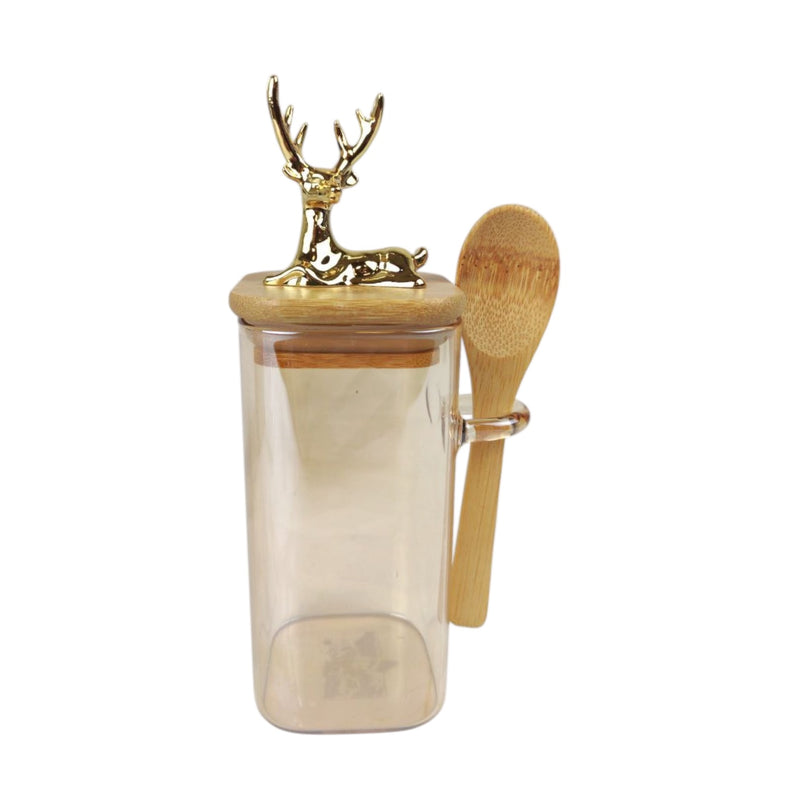 Clear glass jar with wooden lid and spoon, featuring a gold deer figurine on a white background