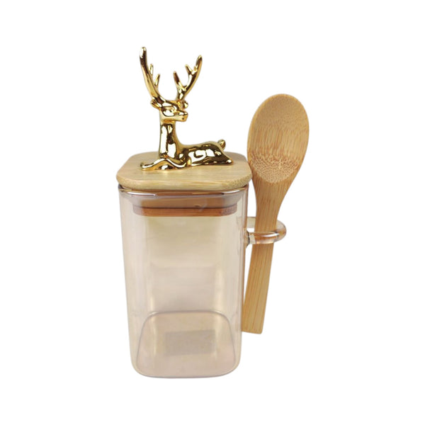 Decorative jar with gold deer lid, clear container, and wooden spoon on a white background