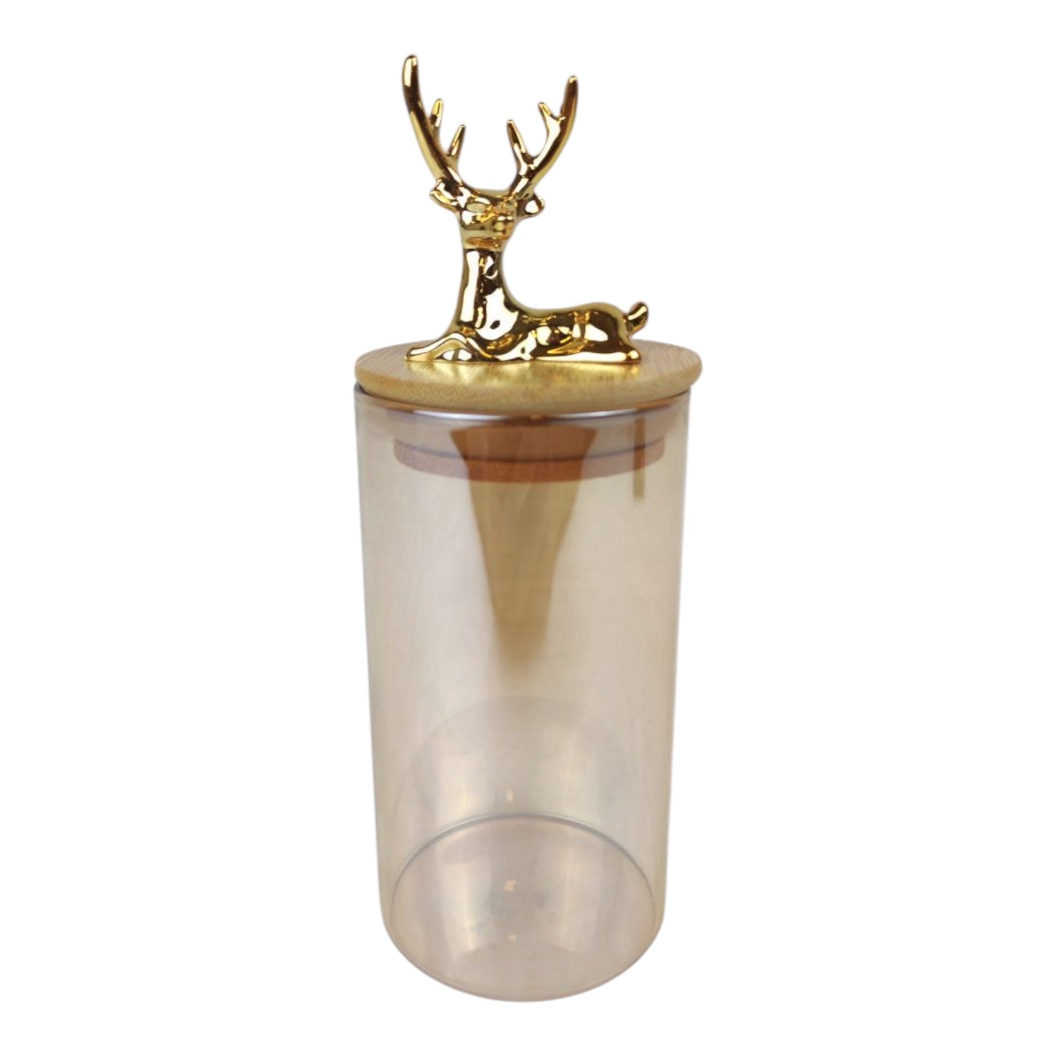 Clear tumbler with a gold deer figurine on top against a white background