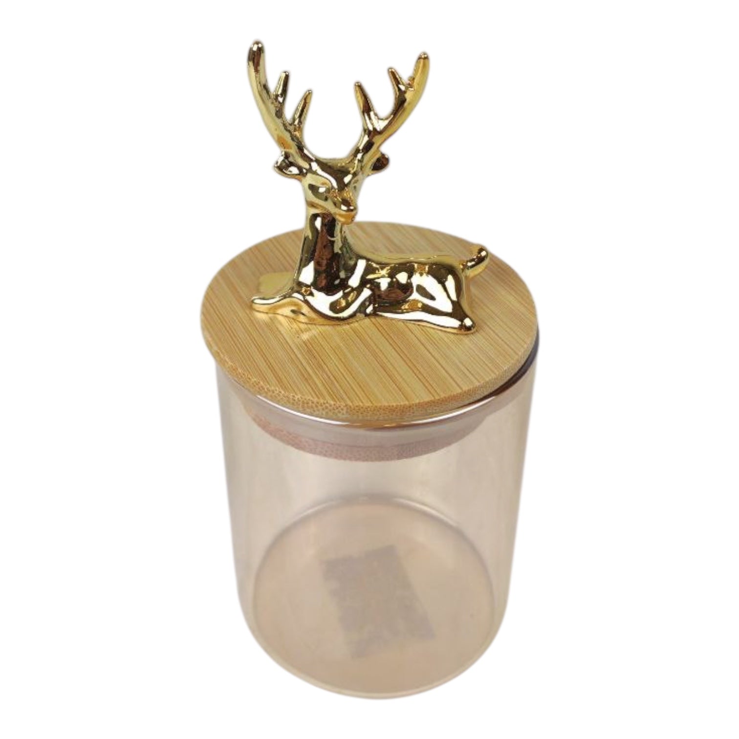 Clear glass jar with a gold deer head lid on a white background