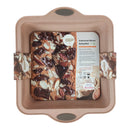 Silicone baking mold with a loaf of bread inside on a white background