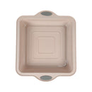 Beige baking dish with handles on a white background