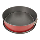 Round baking pan with red exterior and black interior on a white background