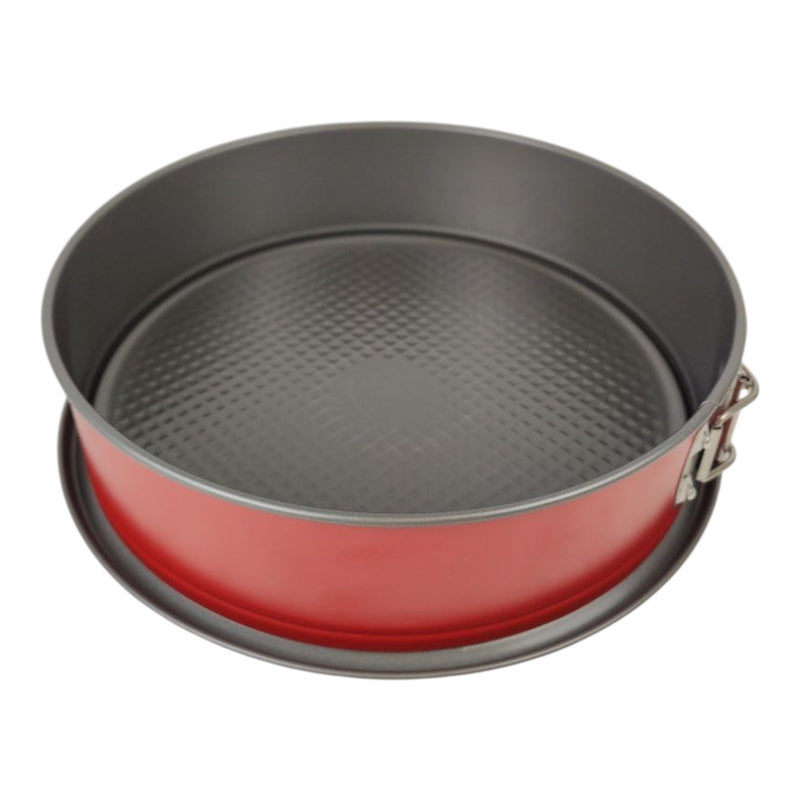 Round baking pan with red exterior and black interior on a white background