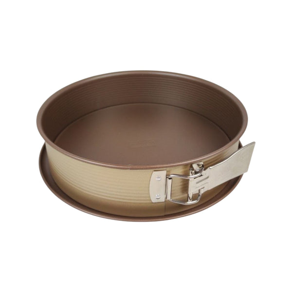 Round metal baking pan with a springform base on a white background