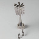 Cleaning brush set with gray bristles and holder on a light gray background