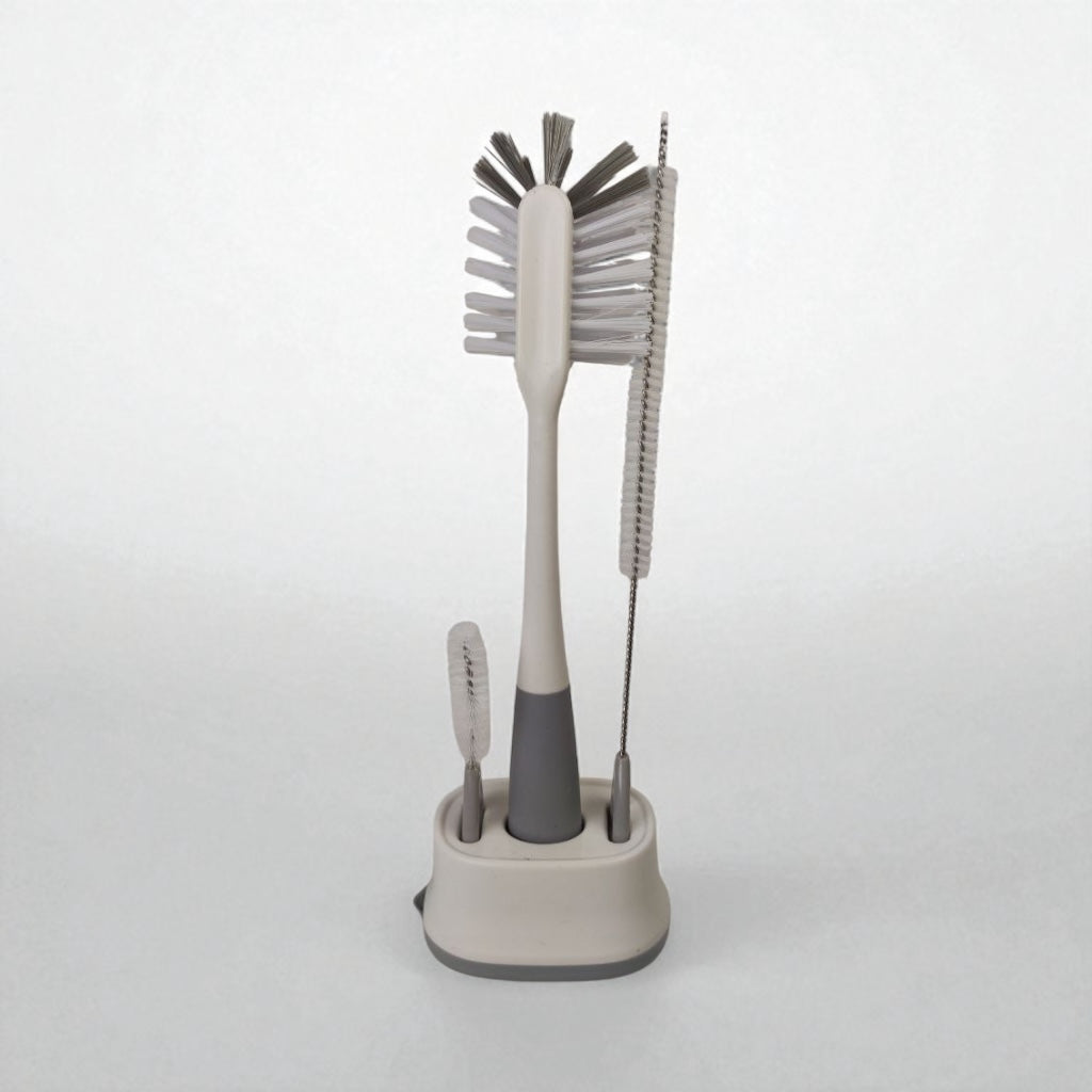 Set of cleaning brushes with a stand on a white background