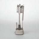 Set of cleaning brushes with a stand on a white background