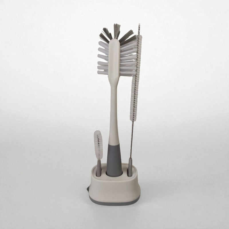 Set of cleaning brushes with a stand on a white background