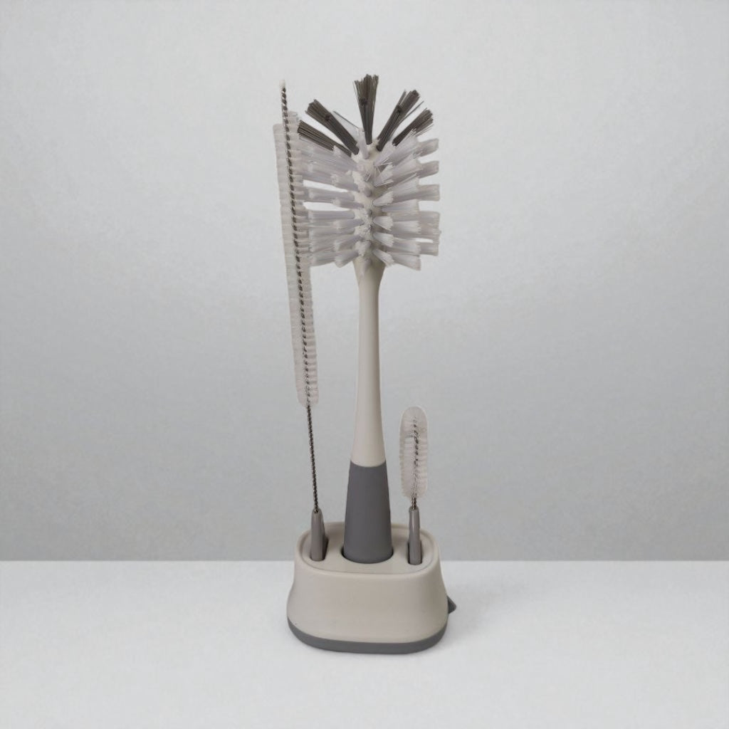 Set of cleaning brushes with a stand on a white background