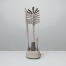 Set of cleaning brushes with a stand on a white background