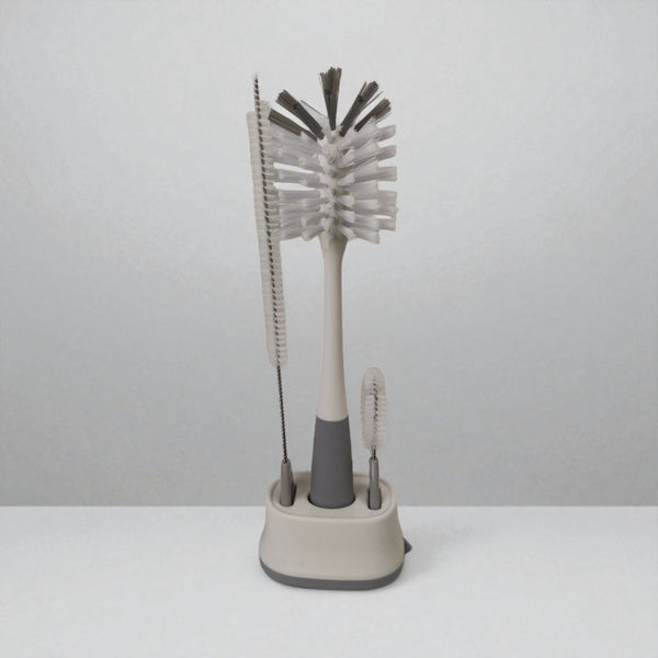 Set of cleaning brushes with a stand on a white background