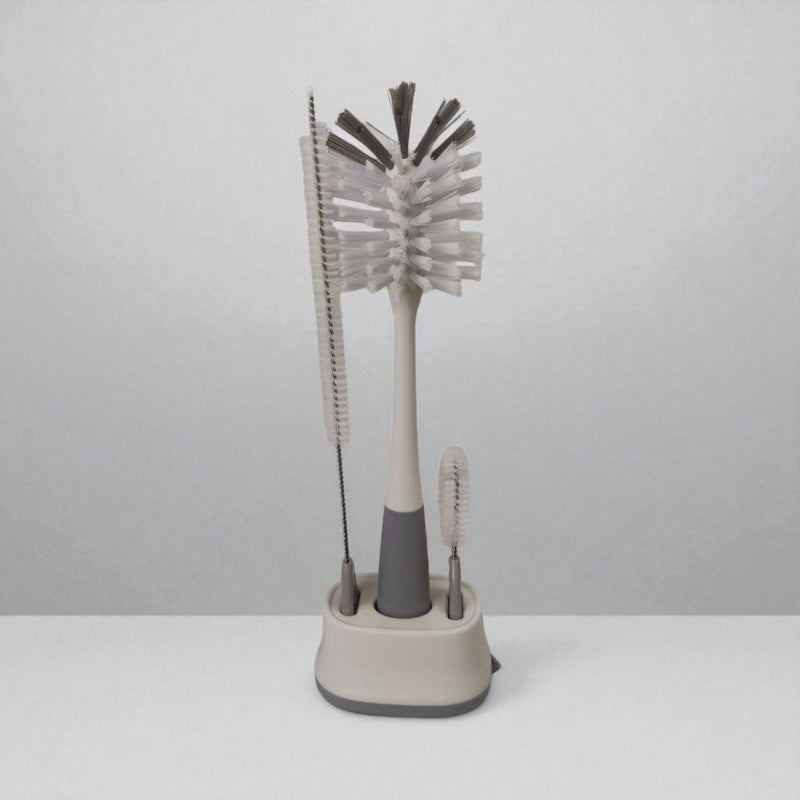 Set of cleaning brushes with a stand on a white background