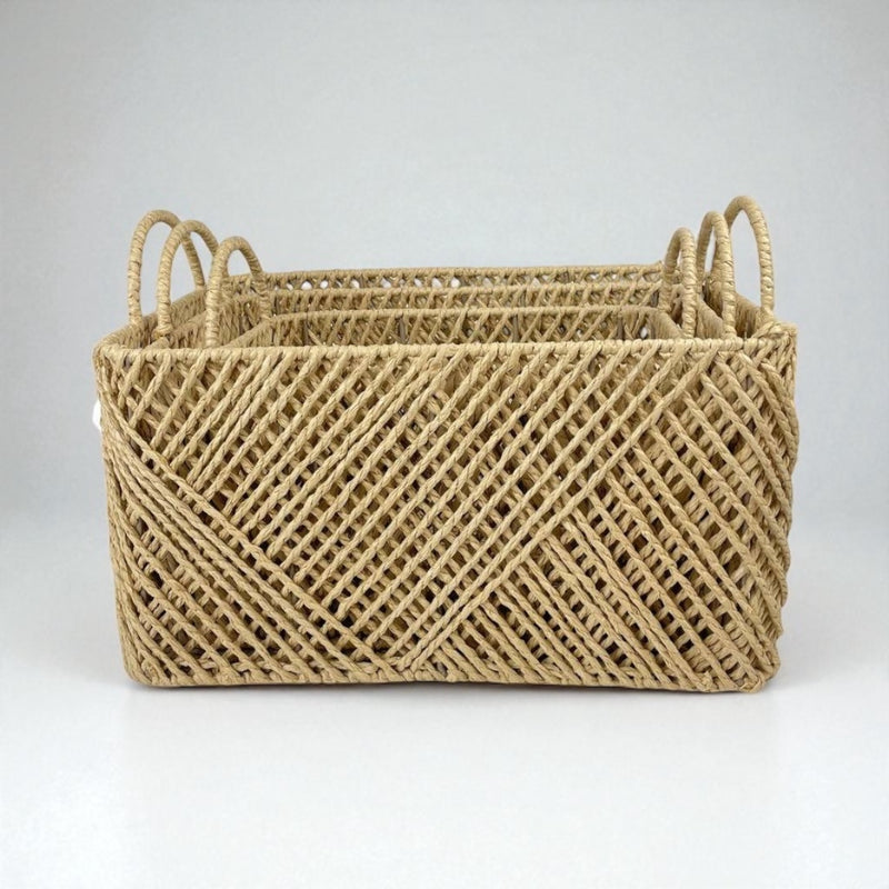 Woven basket with handles on a light gray background