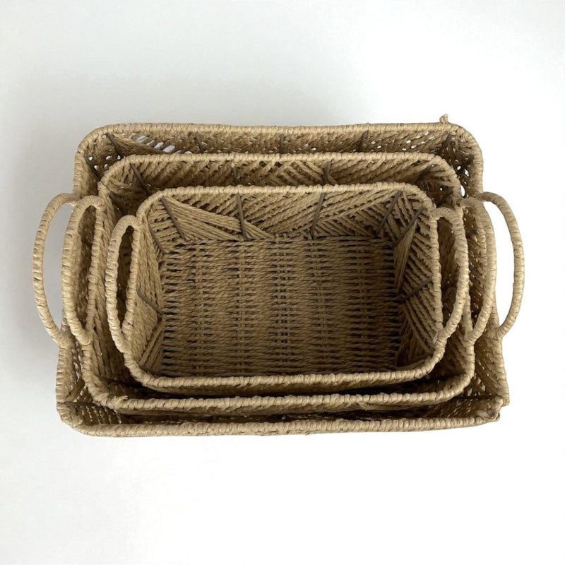 Set of three woven baskets with handles on a white background