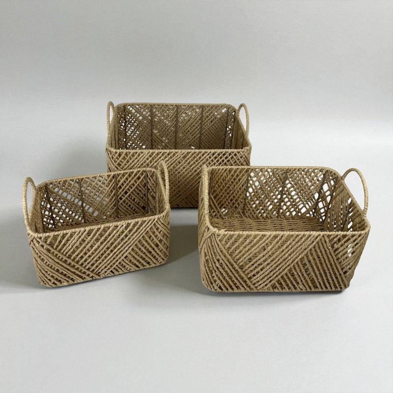 Three woven baskets of different sizes on a light gray background