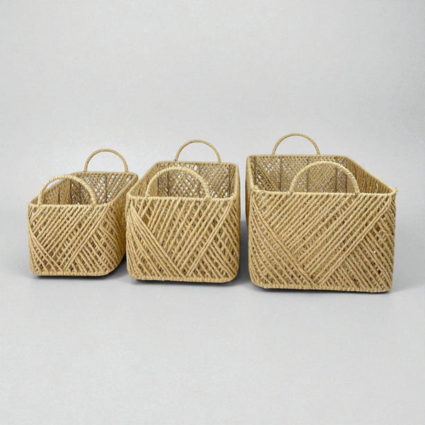 Three woven baskets of different sizes on a light gray background