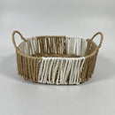 Woven basket with handles on a light gray background