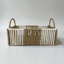 Woven basket with striped pattern on a white background