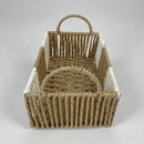 Woven basket with handles on a light gray background