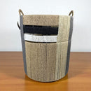 Woven basket with handles on a wooden surface