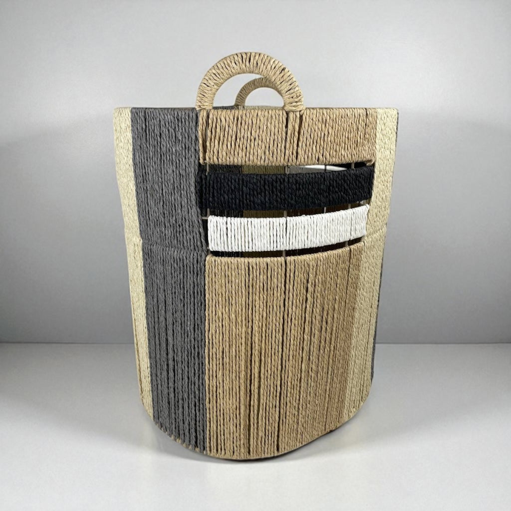 Woven magazine holder with handles on a gray background