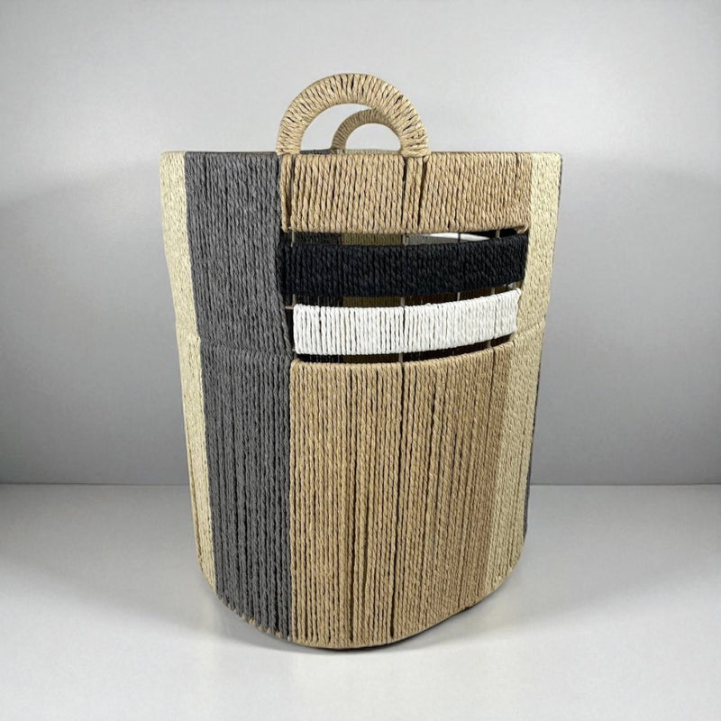 Woven magazine holder with handles on a gray background