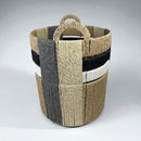 Woven basket with striped pattern on a gray background