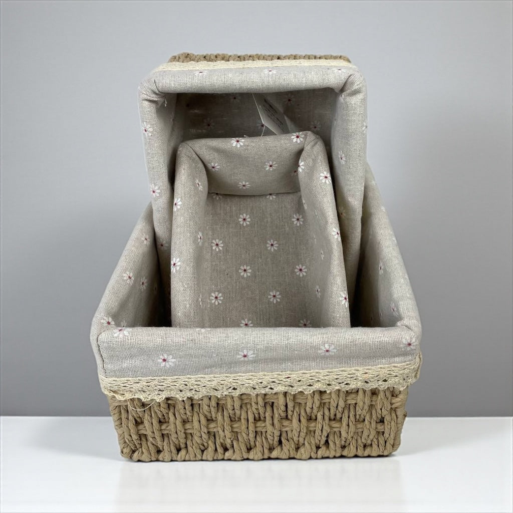 Fabric-covered pet bed with wicker base on a gray background