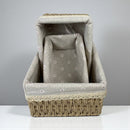 Fabric-covered pet bed with wicker base on a gray background