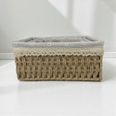 Woven basket with lace trim on a white background