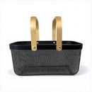 Black woven basket with gold handles on a white background