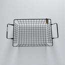 Black wire basket with handles on a light gray background