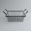 Black metal wire basket with handles on a gray background