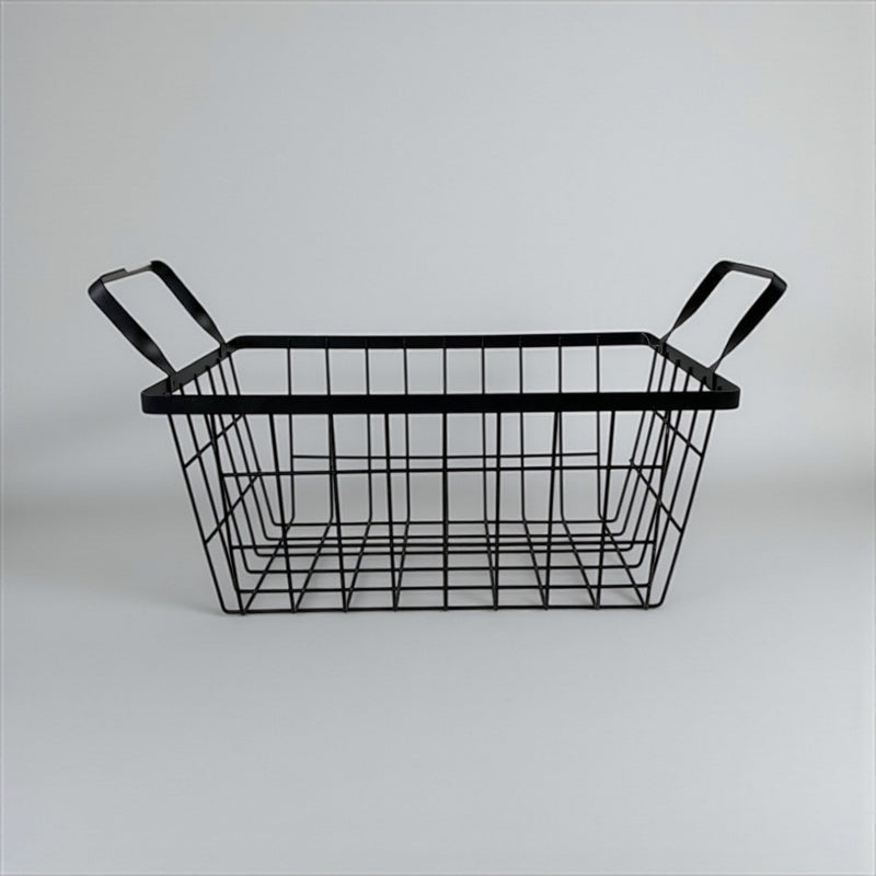 Black wire basket with handles on a light gray background