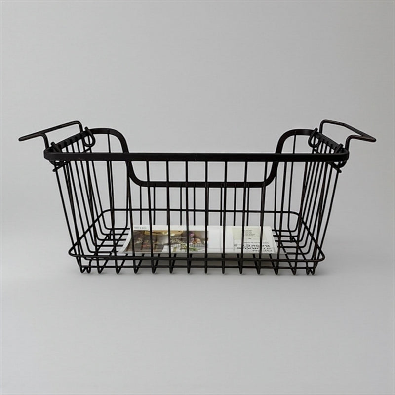 Black wire basket with handles on a gray background