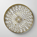 Decorative wall plate with gold geometric pattern on a white background