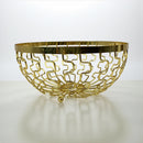 Gold decorative bowl with intricate design on a white background