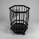 Black metal umbrella stand on a gray background